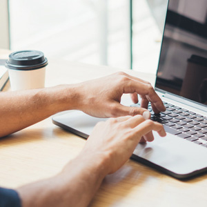 hands typing on a laptop